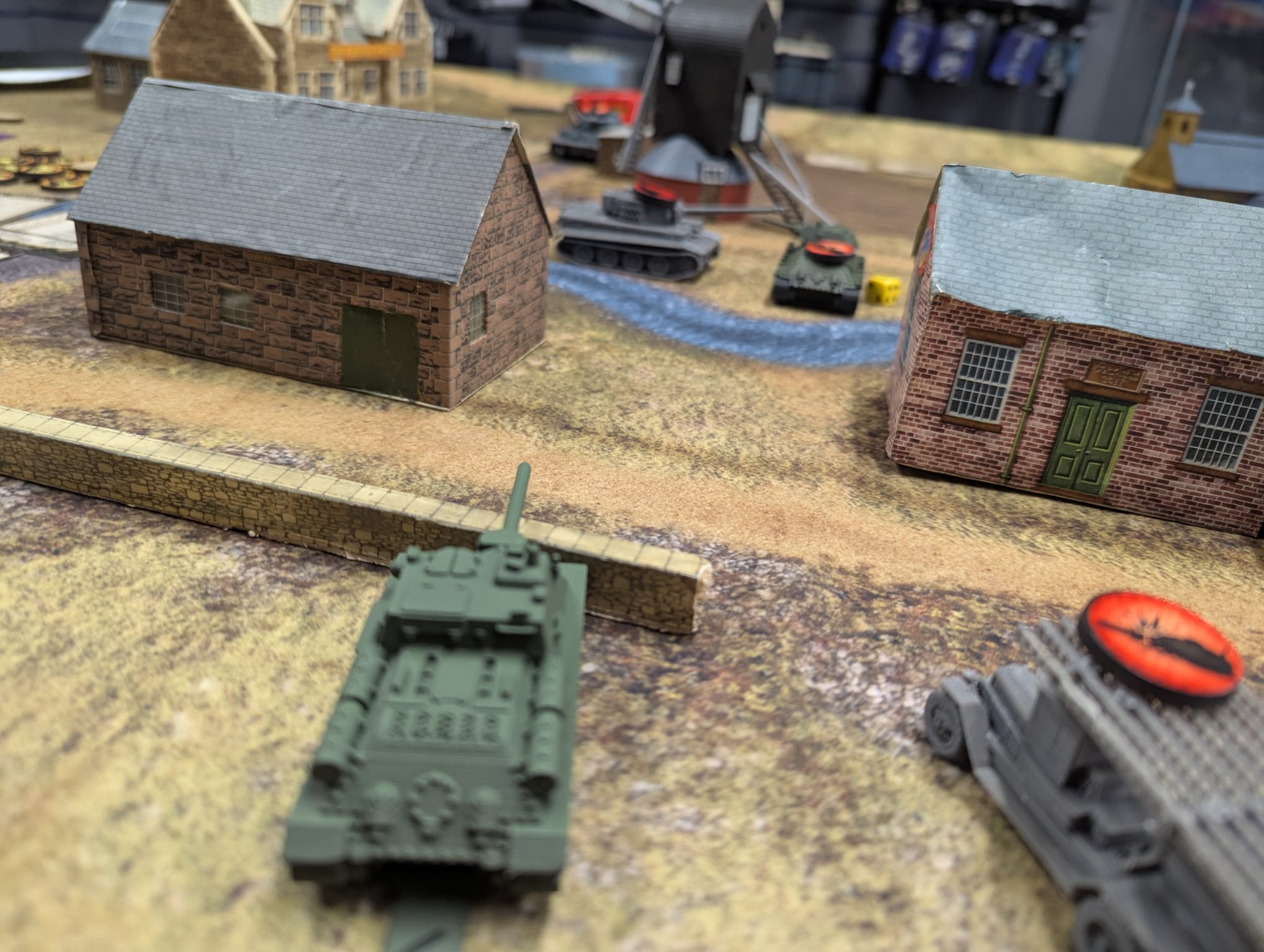 A close tank duel beside card buildings